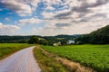 Cloudy sky over a dirt road and farm fields in rural York County Royalty Free Stock Photo