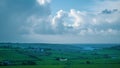 Cloudy sky over the green rolling fields of southern Ireland. Landscape of the southern coast of Ireland with blue sky and clouds Royalty Free Stock Photo