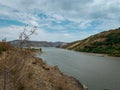 Cloudy sky over rocky hills on the shores of lake waters