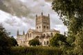 Cloudy sky over Tewkesbury Abbey, Gloucestershire which has a Norman edifice and Romanesque tower Royalty Free Stock Photo