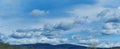 Cloudy sky panorama in spring in rural hilly area Royalty Free Stock Photo