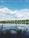 Cloudy sky reflected in the river Royalty Free Stock Photo