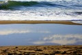 Cloudy sky reflection into water over the beach Royalty Free Stock Photo