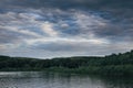 Cloudy sky on the river in the summer evening Royalty Free Stock Photo