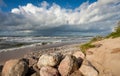 Cloudy sky sea beach and stones Royalty Free Stock Photo