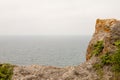 Cloudy sky, sea and a piece of rock