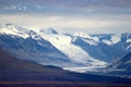 CLOUDY SKY WITH SNOWY MOUNTAINS AND FALL TUNDRA.