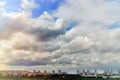 Cloudy sky and sun over the city. A lot of clouds are going to rain. Blue sky and clouds on a summer day Royalty Free Stock Photo