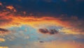 Cloudy sky at sunset. Dark blue and yellow natural background or wallpaper. The rays of the setting sun effectively illuminate the Royalty Free Stock Photo