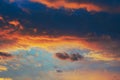 Cloudy sky at sunset. Dark blue and yellow natural background or wallpaper. The rays of the setting sun effectively illuminate the Royalty Free Stock Photo