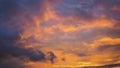 Cloudy sky at sunset. Dark purple and yellow natural background or wallpaper. The rays of the setting sun effectively illuminate Royalty Free Stock Photo