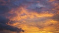 Cloudy sky at sunset. Dark violet-yellow natural background or wallpaper. The rays of the setting sun effectively illuminate the Royalty Free Stock Photo