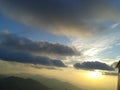 Cloudy sky at sunset over mountain top Royalty Free Stock Photo