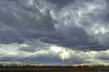 Cloudy sky with thick dense clouds that tightened the whole sky and thin rays of the sun trying to break through them on Royalty Free Stock Photo