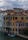 Cloudy sky, venetian architecture and canal in Venice, Italy