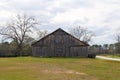 Cloudy sky vintage old barn grass field Royalty Free Stock Photo