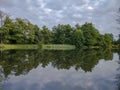 Cloudy spring day beautiful nature reflection on the lake surface Royalty Free Stock Photo