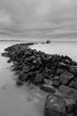 Stone seawalls in Markermeer (Netherlands) withstand the storm and big waves with threatening clouds passing by. Located in West-F Royalty Free Stock Photo