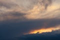 Cloudy stormy sunset with fiery orange glow