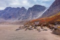 Cloudy summer day in a remote arctic valley of Akshayuk Pass, Baffin Island, Canada. Steep cliffs, glaciers, autumn colors