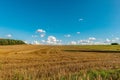 A cloudy summer sky above the field after haymaking