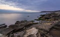 Cloudy sunrise on rocky sea coast, long exposure Royalty Free Stock Photo