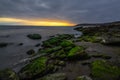 Cloudy sunrise on rocky sea coast, long exposure Royalty Free Stock Photo