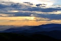 Cloudy sunset over emerald mountain ridges Royalty Free Stock Photo