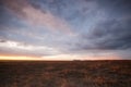 Cloudy sunset over fields