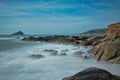 Cloudy surf rolling into rocks at Wembury beach