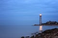 Cloudy twilight seascape with lighthouse