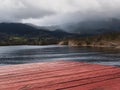 Cloudy view from a floating pier on a lake.