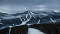 Cloudy view on a ski resort in winter mountains Royalty Free Stock Photo