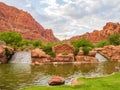 Cloudy view of the Tuacahn entrance sign and pond