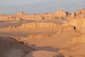 Cloudy, warm morning in the bizzare landscape of Lut desert, the hottest place on earth. Bizzare geological shapes rise Royalty Free Stock Photo