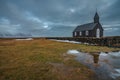 A cloudy winter day at Budir Black Church with a reflection of the