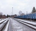 Cloudy winter day with passing freight train. Royalty Free Stock Photo