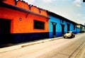 Clourful houses in Mexico with a golden VW Beetle Royalty Free Stock Photo