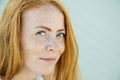 Young girl with red hair and freckles.