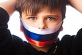 Clouse-up portrait of a boy covers his face with ribbons with flag of Russia. escalation of Ukraine