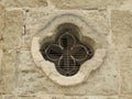 Clove shaped ventilation hole in a sandstone wall Royalty Free Stock Photo