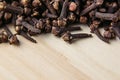 Clove spice closeup on wooden beige background. Royalty Free Stock Photo