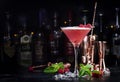 Clover club alcoholic cocktail drink with dry gin, raspberry syrup, lime juice, quail egg white and ice in glass. Black bar Royalty Free Stock Photo