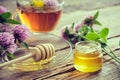 Clover flowers, healthy, herbal tea cup, honey jar and wooden dipper for honey on table Royalty Free Stock Photo