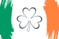Clover leaf on brush stroke background in colors of the irish national flag. Royalty Free Stock Photo