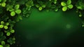 Clover leaves border on a dark green background with bokeh lights Royalty Free Stock Photo