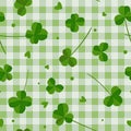 Clover leaves on green checkered background seamless pattern. Lucky shamrock symbol or Saint Patrick Day backdrop. Vector Royalty Free Stock Photo