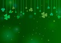 Clover shamrock leaves hung on strings on dark green background. Abstract St. Patrick`s day border