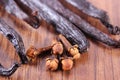 Cloves and fragrant vanilla on wooden board. Seasoning for cooking or baking