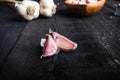 Cloves of garlic on a wooden black table. Fresh garlic bulb with iron garlic press. Vintage background. Farmer. Medicine and healt Royalty Free Stock Photo